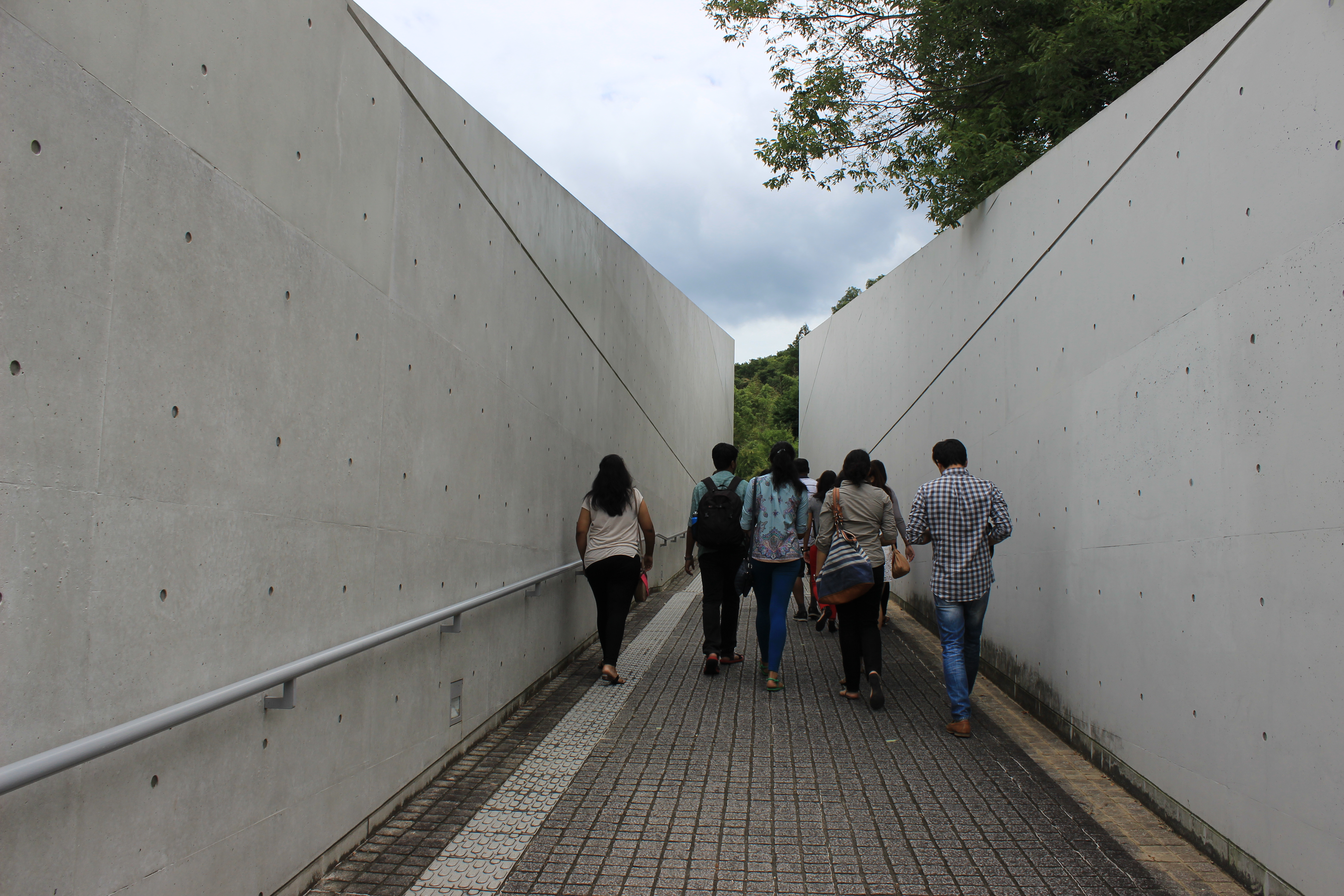 Group walking through concrete corridor